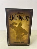 Front view of Disney Villainous Despicable Plots board game box with character silhouette and logo