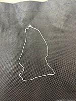 Sterling silver Kezef chain necklace laid flat to show length and clasp