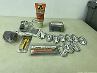 Full lot of new miscellaneous tool accessories and hardware including glue, carabiners, nails, drill bits and wire mesh.