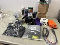 Wide view of entire pet lot spread on table showing all items included in lot