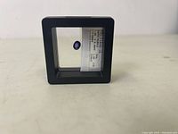 Front view of the purple sapphire in the black protective case showing the oval stone and label.