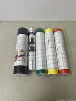 Five rolls of heat transfer vinyl arranged in a row showing their colors and labels.