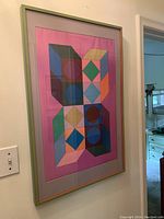 Frontal view of framed abstract geometric print on wall