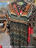 Image showing patterned long sleeve top or dress with geometric, floral design in multicolor tones