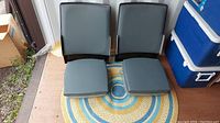Two unassembled grey seat backs and cushions side by side
