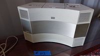 Front view of Bose Wave music system with speaker grille and Bose logo.