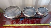 Top view showing three Dixon roto tom drums with tape measure indicating sizes about 10.5, 8.5 and 6.5 inches respectively.