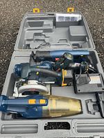 Open gray plastic Ryobi branded carrying case showing the tool set inside.