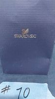 Blue box with gold Swarovski swan logo on lid