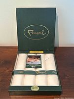 Set of 4 Fingal Irish Damask linen napkins in original green box with gold embossed 'Fingal' branding inside lid.