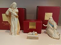 Overview of all three Lennox nativity figurines with original boxes