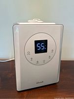 Front view of Levoit humidifier showing digital humidity display and control buttons.