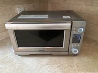 Panasonic stainless steel convection toaster oven front view on counter