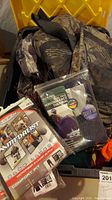 Packed container with various camo clothes and packaged Medalist underwear and Indera thermal socks visible on top.