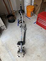 Full view of Echo interchangeable lawn tool attachments showing tiller and hedge trimmer.