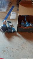 Two vintage Penn freshwater casting reels, one in original box set on a floor surface.