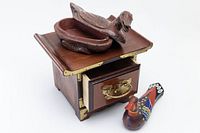 Miniature Korean chest with drawer open, carved wooden duck box on top, and painted wedding duck figurine beside it.