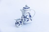 Front and side view of coffee pot and creamer showing blue floral decoration