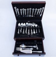 Open wooden box with two drawers of flatware set including lid holding small forks