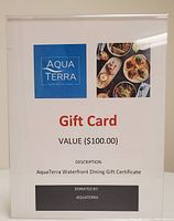 Photo of the AquaTerra Waterfront Dining gift card showing the value, donation, and logo details.