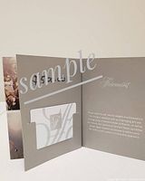 Open tri-fold grey cardstock holder displaying the Fairmont gift card and logo.