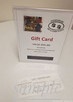 Photo of a gift card and certificate describing the lot for redeeming a 30lb bag of Fromm Classic Dog Food