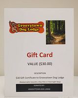Photo of $30 gift certificate card for Groovytown Dog Lodge with logo and forest trail picture.