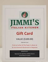 Photo of the gift card voucher for Jimmi's Italian Kitchen with $100 value, showing printed details about location and donor.