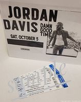 Event poster and two printed tickets displayed together