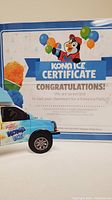 Certificate front showing mascot, truck image, and party details