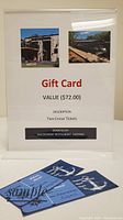 Display of the gift card sign describing the two cruise tickets with value, donor, and sample tickets placed in front.