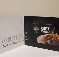 Gift card inside a black and white holder with One Eyed Jack Pub and Grill branding and an image of lamb chops on a plate, showing the $75 value.