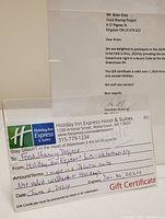 Gift certificate and accompanying donation letter from Holiday Inn Express & Suites Watertown showing certificate details and validity period