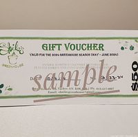 Photo showing a $50 gift voucher for Sheila's Greenhouse valid May-June 2024, printed on paper with green decorative elements and logo.