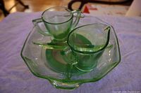 Green uranium glass creamer and sugar bowl on the octagonal 4-section tray. Shows translucency and small nick on tray handle.