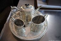 Full view of the Victorian silver plate tea set and tray arranged together.