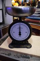 Front view of Salter Family Scale No. 45 with metal bowl, situated on table.