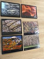 Six framed and unframed photographic art prints laid out on floor