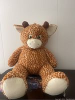 Front view of large stuffed giraffe plush toy showing full body and facial features.