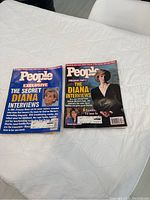 Two People magazines placed on a white table, showing front covers related to Princess Diana features from 1997.