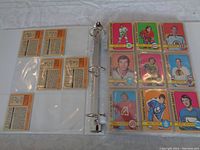 Page of 8 hockey cards visible in protective clear sleeve with backs of cards visible on opposite side.
