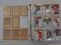 3-ring binder open showing front and back of 1978-79 OPC hockey cards spread across pages with player images on front and stats on back.