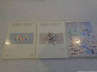 Front view of three unopened Canadian Stamp Souvenir Collection booklets for 1983, 1984, and 1985, showing original shrink wrap and cover designs.