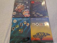 Four sealed Canadian stamp souvenir collections from 1989, 1990, 1991, and 1992 showing the front covers in shrink wrap.