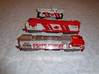 Top and side view of two HO scale Tyco diesel model train engines and one matching caboose on a plain background.