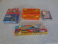 Photo showing complete sets of 1991 and 1992 Topps micro size baseball cards, 1988 OPC complete set in boxes, and an additional smaller stack of cards.