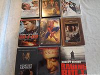 Top layer of DVD cases with titles including Mission Impossible, Spider-Man, Pearl Harbor, Midnight Express, Hannibal, and Raging Bull.