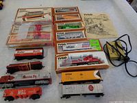 Full lot showcasing boxed and unboxed items including two diesel engines, nine rolling stock pieces, power supply, and instructions.