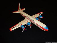 Full view of the vintage metal toy airplane depicting an American Airlines propeller aircraft with registration number on wing.