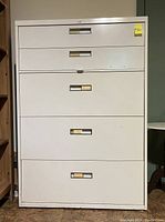 Front view of the white 5 drawer filing cabinet showing five drawers with metal handles and a key lock on top drawer